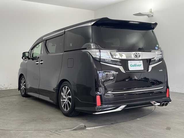トヨタ ヴェルファイア ZA Gエディション 兵庫県 2015(平27)年 5.6万km バーニングブラッククリスタルシャインガラスフレーク ・純正ナビ/TV/Bluetooth/CD/DVD/SD/・全方位カメラ/・レーンキープアシスト/・横滑り防止装置/・前後コーナーセンサー/・クルーズコントロール/・両側パワースライドドア/・パワーバックドア/・ハーフレザーシート/・エグゼクティブシート/・ステアリングヒーター/・スマートキー/・ビルトインETC/・社外前方ドライブレコーダー/・nanoe/・メモリシート/・パワーシート/・オートマチックハイビーム/・ウッドコンビステアリング/・純正フロアマット/・フットイルミネーション/・オットマン/・社外シーケンシャルウインカー/・モデリスタエアロ/・社外車高調/・社外リアリフレクター/・純正17インチアルミホイール/・LEDオートライト/・LEDフォグランプ/・取扱説明書