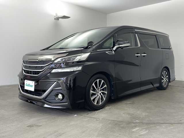 トヨタ ヴェルファイア ZA Gエディション 兵庫県 2015(平27)年 5.6万km バーニングブラッククリスタルシャインガラスフレーク ・純正ナビ/TV/Bluetooth/CD/DVD/SD/・全方位カメラ/・レーンキープアシスト/・横滑り防止装置/・前後コーナーセンサー/・クルーズコントロール/・両側パワースライドドア/・パワーバックドア/・ハーフレザーシート/・エグゼクティブシート/・ステアリングヒーター/・スマートキー/・ビルトインETC/・社外前方ドライブレコーダー/・nanoe/・メモリシート/・パワーシート/・オートマチックハイビーム/・ウッドコンビステアリング/・純正フロアマット/・フットイルミネーション/・オットマン/・社外シーケンシャルウインカー/・モデリスタエアロ/・社外車高調/・社外リアリフレクター/・純正17インチアルミホイール/・LEDオートライト/・LEDフォグランプ/・取扱説明書