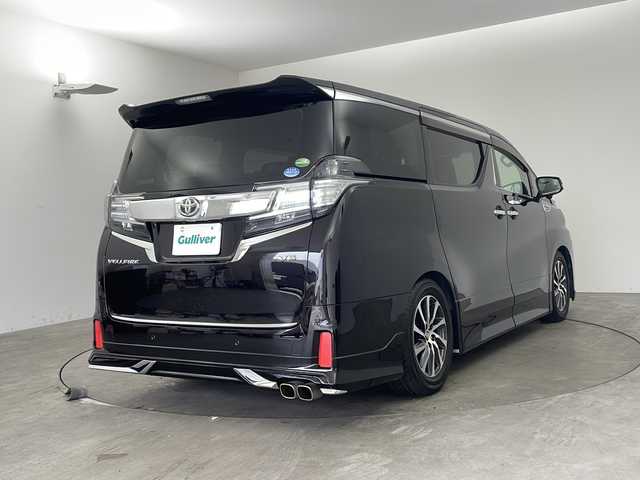 トヨタ ヴェルファイア ZA Gエディション 兵庫県 2015(平27)年 5.6万km バーニングブラッククリスタルシャインガラスフレーク ・純正ナビ/TV/Bluetooth/CD/DVD/SD/・全方位カメラ/・レーンキープアシスト/・横滑り防止装置/・前後コーナーセンサー/・クルーズコントロール/・両側パワースライドドア/・パワーバックドア/・ハーフレザーシート/・エグゼクティブシート/・ステアリングヒーター/・スマートキー/・ビルトインETC/・社外前方ドライブレコーダー/・nanoe/・メモリシート/・パワーシート/・オートマチックハイビーム/・ウッドコンビステアリング/・純正フロアマット/・フットイルミネーション/・オットマン/・社外シーケンシャルウインカー/・モデリスタエアロ/・社外車高調/・社外リアリフレクター/・純正17インチアルミホイール/・LEDオートライト/・LEDフォグランプ/・取扱説明書