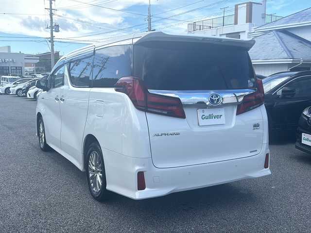 トヨタ アルファードハイブリット SR 沖縄県 2019(令1)年 6.1万km ホワイトパールクリスタルシャイン 社外９インチナビ　/（ＡＭ／ＦＭ／ＣＤ／ＤＶＤ／ＢＴ）　/バックカメラ　/フルセグＴＶ　/サンルーフ　/後席モニター　/パワーシート　/シートヒーター　/両側パワスラ　/レザーシート　/コーナーセンサー/オットマン/純正フロアマット/純正17AW/クルーズコントロール/LEDヘッドライト/オートライト/ドラレコ
