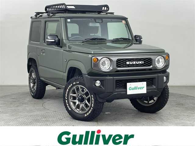 スズキ ジムニー XC 道央・札幌 2024(令6)年 2万km ジャングルグリーン ・４WD/・オープンカントリーホワイトレタータイヤ/・ルーフキャリア/・社外ナビ/・フルセグ/・ETC/・衝突軽減ブレーキ/・クルーズコントロール/・レーンキープアシスト/・前席シートヒーター/・アイドリングストップ/・ダウンヒルアシストコントロール/・LEDヘッドライト/・ヘッドライトウォッシャー/・純正フロアマット/・純正16インチAW