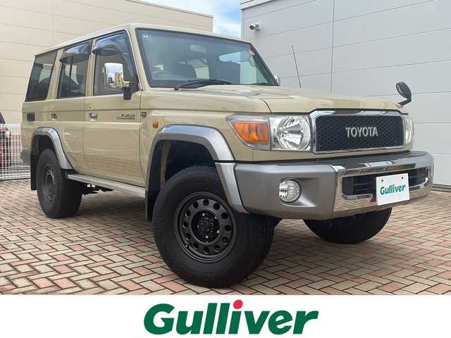 トヨタ ランドクルーザー 鳥取県 2015(平27)年 10万km ベージュ ワンオーナー/30thエンブレム/30th背面ソフトカバー/JAOS製16インチAW/全面クリアガラス/純正タンレザー車検証ケース/純正キーBOX/純正キーレスx２個/トランスファ4WD/５速マニュアル/センターデフロック/社外メモリナビ/フルセグ・Bluetooth/バックカメラ/社外後席モニター/社外ドライブレコーダー/リアクーラー・ヒーター/前席シートヒーター/純正ゴムマット/サイドステップ/電動オートアンテナ/メッキグリル/純正AWスタットレス4本積込/保証書・取説