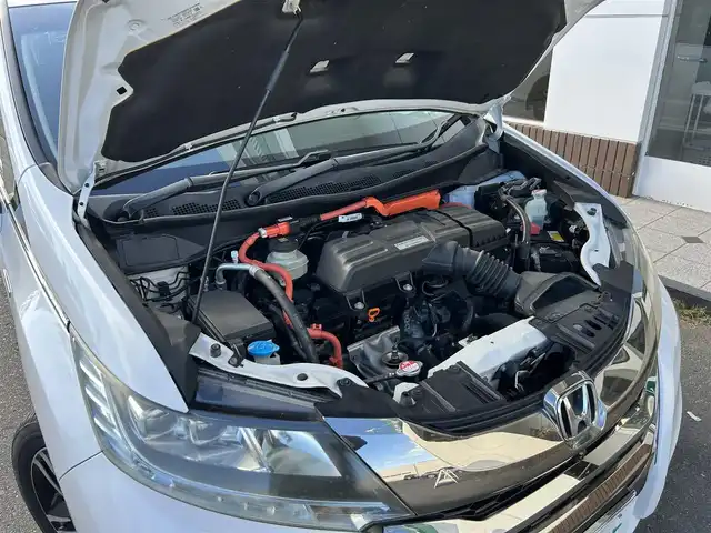 ホンダ オデッセイ ハイブリッド アブソルートセンシングEXパック 静岡県 2016(平28)年 7.4万km ホワイトオーキッドパール ホンダセンシング/1.衝突軽減ブレーキ/2.誤発進抑制機能/3.歩行者事故低減ステアリング/4.路外逸脱抑制機能/5.アダプティブクルーズコントロール/6.車線維持支援システム/7.先行車発進お知らせ機能/8.標識認識機能/9.後方誤発進抑制機能/10.近距離衝軽減ブレーキ/11.オートハイビーム/12.アダプティブドライビングビーム（車速可変照明角度）/13トラフィックジャムアシスト（渋滞運転支援機能）/純正8インチナビ/FM/AM/CD/DVD/Bluetooth/iPod/レーダークルーズコントロール/フリップダウンモニター/両側パワースライドドア/全周囲カメラ/ビルトインETC/前後ドラレコ/ハーフレザーシート/オットマン/ウォークスルー/オートライト