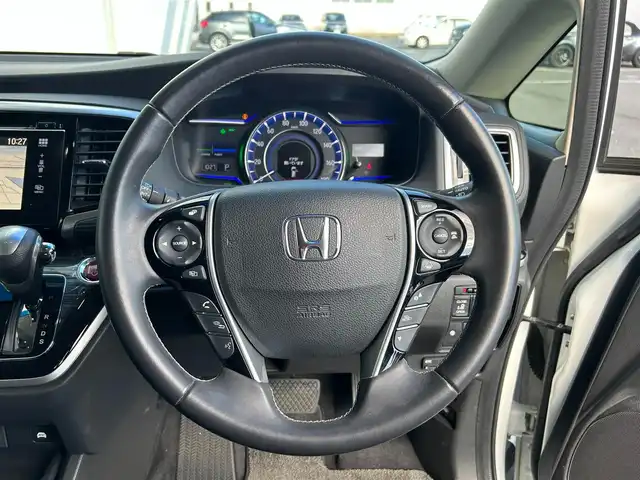 ホンダ オデッセイ ハイブリッド アブソルートセンシングEXパック 静岡県 2016(平28)年 7.4万km ホワイトオーキッドパール ホンダセンシング/1.衝突軽減ブレーキ/2.誤発進抑制機能/3.歩行者事故低減ステアリング/4.路外逸脱抑制機能/5.アダプティブクルーズコントロール/6.車線維持支援システム/7.先行車発進お知らせ機能/8.標識認識機能/9.後方誤発進抑制機能/10.近距離衝軽減ブレーキ/11.オートハイビーム/12.アダプティブドライビングビーム（車速可変照明角度）/13トラフィックジャムアシスト（渋滞運転支援機能）/純正8インチナビ/FM/AM/CD/DVD/Bluetooth/iPod/レーダークルーズコントロール/フリップダウンモニター/両側パワースライドドア/全周囲カメラ/ビルトインETC/前後ドラレコ/ハーフレザーシート/オットマン/ウォークスルー/オートライト