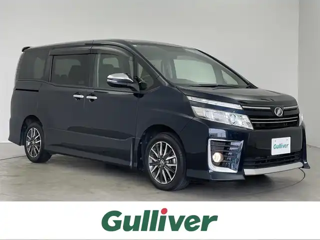 トヨタ ヴォクシー ZS 煌 埼玉県 2015(平27)年 6.4万km ブラッキッシュアゲハガラスフレーク 純正9インチSDナビ　NSZT-Y64T/(AM/FM/CD/DVD/TV/BT)/フリップダウンモニター V11T-R62C/両側パワースライドドア/バックカメラ/オートライト/LEDヘッドライト/ビルドインETC/プッシュスタート/スマートキー/純正16インチアルミホイール/純正フロアマット/ウォークスルー/ドアバイザー/電格ミラー