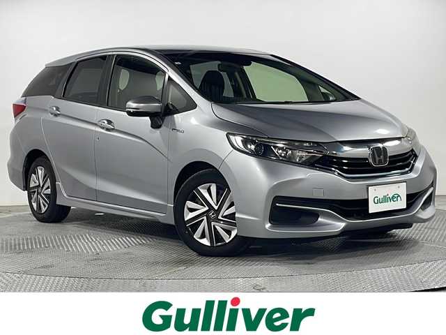 ホンダ シャトル ハイブリッド ホンダセンシング 広島県 2018(平30)年 2.1万km ルナシルバーM 社外ナビ　/バックカメラ　/衝突軽減ブレーキ　/レーンキープアシスト　/スマートキー　/Bluetooth　/踏み間違い防止　/横滑り防止　/オートエアコン　/DVD　/ヘッドライトレベライザー　/電動格納ミラー　/ETC/純正１５インチホイールキャップ(185/60/R15)/エアバック（運転席/助手席）