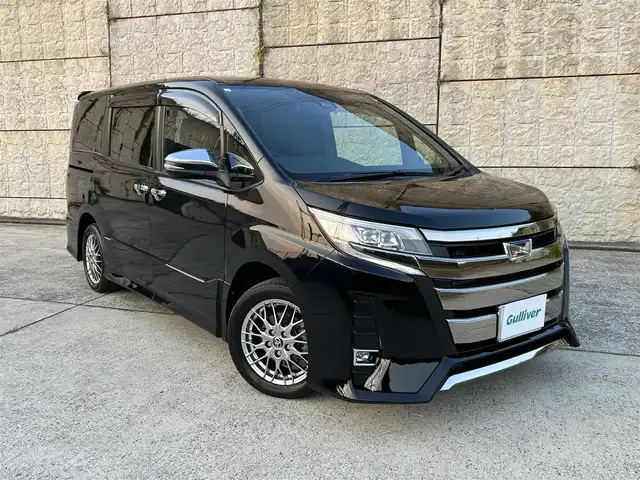 トヨタ ノア ハイブリッド Si ダブルバイビーⅢ 長崎県 2021(令3)年 7.3万km ブラック ワンオーナー/純正9インチナビ/（CD/DVD/BT/フルセグ）/バックカメラ/フリップダウンモニター/衝突軽減システム/レーンアシスト/両側パワースライドドア/クルーズコントロール/ビルトインETC/前席シートヒーター/オートライト/純正16インチAW