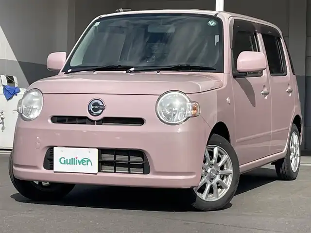 ダイハツ ミラ ココア L 青森県 2015(平27)年 5万km ムースピンクパール ・純正CD/・社外ポータブルナビ/・ワンセグTV/・アイドリングストップ/・電格ドアミラー/・社外１４インチアルミホイール/・純正フロアマット/・ドアバイザー/・新車時保証書/・取扱説明書