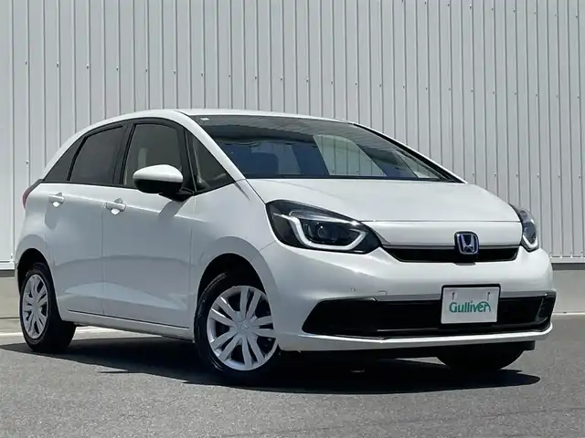 ホンダ フィット e:HEVホーム 群馬県 2024(令6)年 0.2万km プラチナホワイトパール ホンダセンシング/・衝突軽減ブレーキ/・パーキングセンサー警報/・踏み間違い防止/・路外逸脱抑制/純正9インチSDナビ　VXU-245FTi/　(CD DVD Bluetooth SD フルセグ　AM FM）/バックカメラ/LEDヘッドライト/オートライト/クルーズコントロール/USB/純正フロアマット