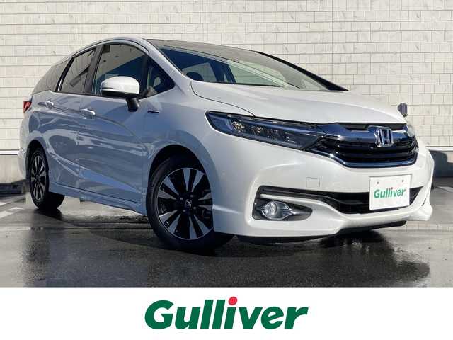 ホンダ シャトル ハイブリッド X 静岡県 2015(平27)年 8.6万km ホワイトオーキッドパール あんしんパッケージ/純正メモリーナビ/　AM FM CD DVD Bluetooth USB/ビルトインETC/前方ドライブレコーダー/LEDオートヘッドランプ/ハーフレザーシート/クルーズコントロール/純正15インチアルミホイール/スマートキー2本/パーキングアシスト/パドルシフト/フロントフォグランプ/シティブレーキアクティブシステム/フルセグTV/バックモニター