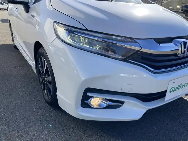 ホンダ シャトル ハイブリッド X 静岡県 2015(平27)年 8.6万km ホワイトオーキッドパール あんしんパッケージ/純正メモリーナビ/　AM FM CD DVD Bluetooth USB/ビルトインETC/前方ドライブレコーダー/LEDオートヘッドランプ/ハーフレザーシート/クルーズコントロール/純正15インチアルミホイール/スマートキー2本/パーキングアシスト/パドルシフト/フロントフォグランプ/シティブレーキアクティブシステム/フルセグTV/バックモニター
