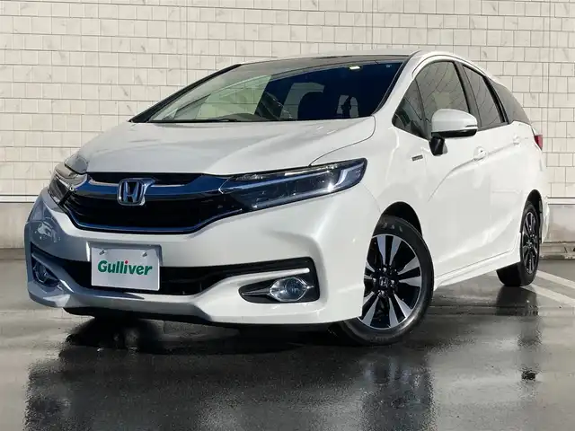 ホンダ シャトル ハイブリッド X 静岡県 2015(平27)年 8.6万km ホワイトオーキッドパール あんしんパッケージ/純正メモリーナビ/　AM FM CD DVD Bluetooth USB/ビルトインETC/前方ドライブレコーダー/LEDオートヘッドランプ/ハーフレザーシート/クルーズコントロール/純正15インチアルミホイール/スマートキー2本/パーキングアシスト/パドルシフト/フロントフォグランプ/シティブレーキアクティブシステム/フルセグTV/バックモニター