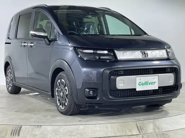 ホンダ フリード ハイブリット e:HEV クロスター 福岡県 2025(令7)年 0.1千km メテオロイドグレーメタリック 登録済未使用車/純正9インチナビ（LXM-242ZFNi)/フルセグ/Ｂｌｕｅｔｏｏｔｈ/AppleCarPiay/AndroidAuto/USB/両側パワースライドドア　/ホンダセンシング　/衝突軽減/踏み間違い防止/先行車発進お知らせ/レーダークルーズコントロール/ロードサインアシスト/Ｗエアコン/バックカメラ/シートヒーター/プッシュスタート/スマートキー/スペアキー/保証書/取扱説明書
