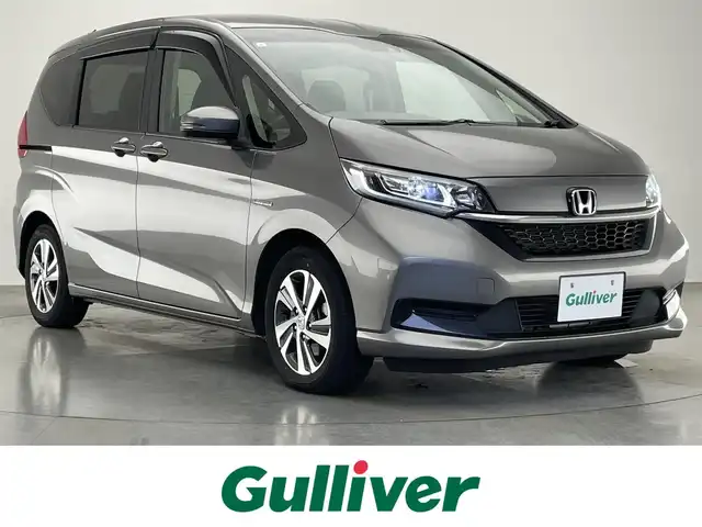 ホンダ フリード ハイブリット G ホンダセンシング 愛知県 2021(令3)年 5.5万km スーパープラチナグレーメタリック 社外８型ナビ　社外後席モニター　禁煙　黒ハーフレザー　ＨＤＭＩ　両側パワスラ　ＥＴＣ　シートヒーター　ホンダセンシング　衝突軽減　追従クルコン　フルセグＴＶ　カープレイ　ＤＶＤ　ＬＥＤオートライト