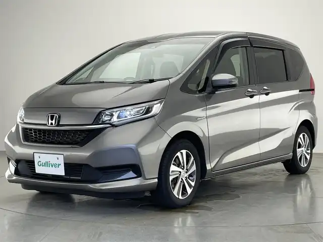 ホンダ フリード ハイブリット G ホンダセンシング 愛知県 2021(令3)年 5.5万km スーパープラチナグレーメタリック 社外８型ナビ　社外後席モニター　禁煙　黒ハーフレザー　ＨＤＭＩ　両側パワスラ　ＥＴＣ　シートヒーター　ホンダセンシング　衝突軽減　追従クルコン　フルセグＴＶ　カープレイ　ＤＶＤ　ＬＥＤオートライト