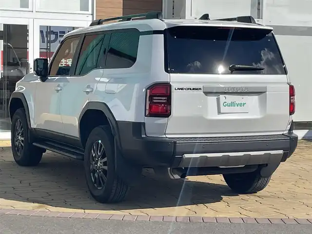 トヨタ ランドクルーザー ２５０ VX 宮崎県 2024(令6)年 1.2万km プラチナホワイトパールマイカ 純正12.3インチディスプレイオーディオ/（フルセグ/BT/HDMI/Miracast）/パノラミックビューモニター/デジタルインナーミラー/ETC2．0/サンルーフ/トヨタセーフティセンス/ブラインドスポットモニター/レーンキープアシスト/クリアランスソナー/レーダークルーズコントロール/前席シートヒーター/エアシート/運転席パワーシート/LEDヘットライト/フォグライト/純正18インチアルミホイール/プッシュエンジンスタート/スマートキー/フロアマット