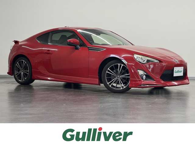 トヨタ ８６ GT リミテッド 三重県 2012(平24)年 2.8万km ライトニングレッド プレミアムガソリン/FR/6F/純正 7インチナビ NSZT-W62G/（AM/FM/CD/DVD/SD/SDREC/TV/DS/Bluetooth）/ETC/モデリスタエアロ（F/S/R）/［TRD］エアロスタビライジングカバー（リヤガラスとトランクドアの間を埋めるパーツ）/ルーフスポイラー［社外品：Grazio&Co.（グラージオ・アンド・シーオー）］/トランクスポイラー［GT Limited標準装備］/安全/・ABS/・VSC（ビークル・スタビリティ・コントロール）/・トラクションコントロール（TRACK機能付）/・ヒルスタートアシスト/・緊急ブレーキシグナル/・SRS 運転席・助手席＋サイド＋カーテンシールドエアバッグ/装備/・ハーフレザーシート（本革×アルカンターラ）/・シートヒーター（D/N）/・左右独立オートエアコン/・コンライト（ヘッドライト自動点灯・自動消灯システム）/・LEDヘッドランプ/・フロント（LED）＆リヤフォグランプ/・電動格納ドアミラー/・パワーステアリング/・パワーウインドウ/・プッシュスタート/・純正17inAW/・スマートキーx2/など