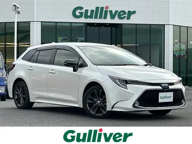 トヨタ カローラツーリング ハイブリッド ダブルバイビー 島根県 2021(令3)年 7万km ホワイトパールクリスタルシャイン 登録時走行距離　69594km/純正ナビ/Bluetooth/バックカメラ/レーダークルーズコントロール/電動パーキング/電動格納ミラー/コーナーセンサー/オートハイビーム/シートヒーター（DN席）/ステアリングヒーター/ステアリングスイッチ/スマートキー/スペアキー/レーントレーシングアシスト/プリクラッシュセーフティシステム/パーキングサポートブレーキ/ロードサインアシスト/純正フロアマット/ビルドインETC2.0/ドライブレコーダー前後/純正アルミ１７インチ