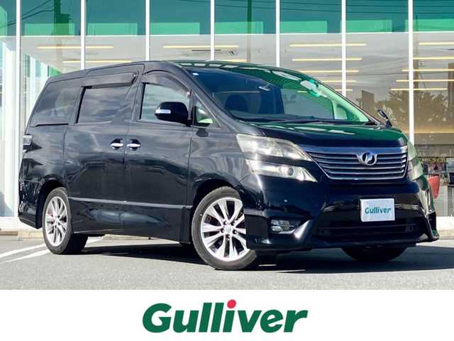 トヨタ ヴェルファイア 2．4Z プラチナセレクションⅡ 静岡県 2011(平23)年 7.4万km 黒 エンジンスタートボタン/パワーステアリング/パワーウィンドウ/スマートキー/Wオートエアコン/スペアキー１本/フリップダウンモニター/ETC/8インチナビ（CD/DVD/BT/フルセグ）/三列シート/オットマン/電動リアゲート/ウォークスルー/フロアマット/両側パワースライドドア/純正アルミホイール/ABS/横滑り防止装置/コーナーセンサー前後/オートライト/W＋サイドエアバック/カーテンエアバック