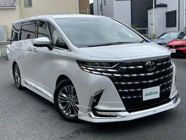 トヨタ アルファード Z 神奈川県 2024(令6)年 0.1万km プラチナホワイトパールマイカ ワンオーナー/モデリスタエアロ/マフラー/左右独立ムーンルーフ/ユニバーサルステップ/黒革シート/純正メモリーナビ・地デジTV/純正13.2インチ有機ELフリップダウンモニター/全方位カメラ/USB/BT/Miracast/HDMI再生/ワイヤレス充電/ビルトインETC2.0/前後ドライブレコーダー/トヨタセーフティセンス/両側パワースライドドア/純正18インチAW/LEDライト/LEDフォグ/パワーバックドア/コーナーセンサー/プッシュスタート/スマートキー×2/AC100V/ステアスイッチ/R7年ディーラー整備記録/保証書・ユーザーガイドあり