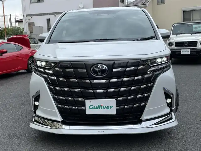 トヨタ アルファード Z 神奈川県 2024(令6)年 0.1万km プラチナホワイトパールマイカ ワンオーナー/モデリスタエアロ/マフラー/左右独立ムーンルーフ/ユニバーサルステップ/黒革シート/純正メモリーナビ・地デジTV/純正13.2インチ有機ELフリップダウンモニター/全方位カメラ/USB/BT/Miracast/HDMI再生/ワイヤレス充電/ビルトインETC2.0/前後ドライブレコーダー/トヨタセーフティセンス/両側パワースライドドア/純正18インチAW/LEDライト/LEDフォグ/パワーバックドア/コーナーセンサー/プッシュスタート/スマートキー×2/AC100V/ステアスイッチ/R7年ディーラー整備記録/保証書・ユーザーガイドあり
