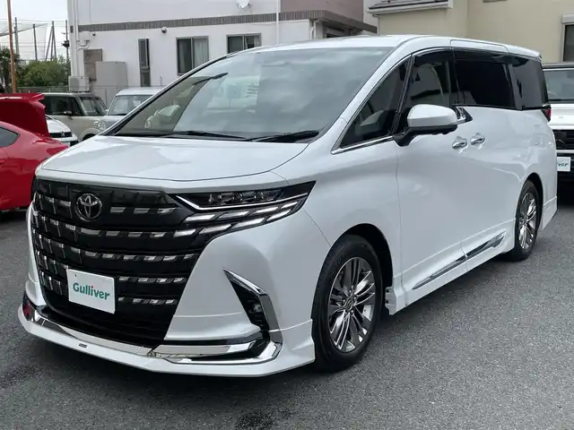 トヨタ アルファード Z 神奈川県 2024(令6)年 0.1万km プラチナホワイトパールマイカ ワンオーナー/モデリスタエアロ/マフラー/左右独立ムーンルーフ/ユニバーサルステップ/黒革シート/純正メモリーナビ・地デジTV/純正13.2インチ有機ELフリップダウンモニター/全方位カメラ/USB/BT/Miracast/HDMI再生/ワイヤレス充電/ビルトインETC2.0/前後ドライブレコーダー/トヨタセーフティセンス/両側パワースライドドア/純正18インチAW/LEDライト/LEDフォグ/パワーバックドア/コーナーセンサー/プッシュスタート/スマートキー×2/AC100V/ステアスイッチ/R7年ディーラー整備記録/保証書・ユーザーガイドあり