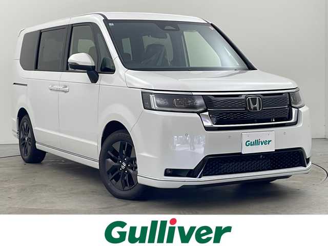 ホンダ ステップワゴン スパーダ プレミアムライン 秋田県 2025(令7)年 0.1千km プラチナホワイトパール ４ＷＤ/ホンダセンシング/9インチホンダコネクトナビ/　(フルセグTV/Bluetooth/USB/ACP/AA)/マルチビューカメラ/寒冷地仕様/レーダークルーズコントロール/パドルシフト/両側パワースライドドア/パワーバックドア/ブラインドスポットモニター/コンビシート/オットマン/純正フロアマット/前席・2列目シートヒーター/オートライト/スマートキー/スペアキー/ＬＥＤヘッドライト