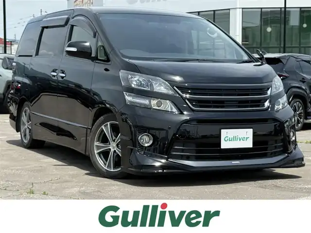 トヨタ ヴェルファイア 2．4Z ゴールデンアイズ 道南・函館 2013(平25)年 8.4万km ブラック 純正ナビ/フルセグＴＶ/エンジンスターター/ダウンサス/ＴＲＤエアロ/バックカメラ/クルーズコントロール/フリップダウンモニター/コーナーセンサー/パワーバックドア/オートライト/横滑り防止装置