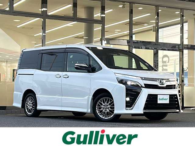 トヨタ ヴォクシー ハイブリッド ZS 煌Ⅱ 福島県 2020(令2)年 8.1万km ホワイトパールクリスタルシャイン 登録時走行距離　　80714ｋｍ/ワンオーナー/純正SDナビ/(AM/FM/CD/DVD/BT/フルセグTV)/プッシュスタート/電動格納ミラー/パワースライドドア/レーンディパーチャーアラート/オートライト/オートマチックハイビーム/純正フォグランプ/純正AW/寒冷地仕様/コーナーセンサー/クルコン/センターコンソール/サイドバイザー/純正マット/衝突軽減システム/ETC/フリップダウン/シートヒータ/2.1V充電端子/社外ドラレコ/ウィンカーミラー