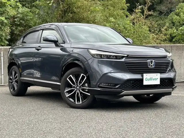 ホンダ ヴェゼル ハイブリッド e:HEV Z 長崎県 2023(令5)年 1.3万km メテオロイドグレーメタリック ワンオーナー/プッシュスタート/保証書/取扱説明書/スマートキー/渋滞追従機能付きアダプティブクルーズコントロール/Hondaコネクトディスプレイ(BT/AM/FM/フルセグ/ナビ)/USB入力端子/ETC2.0/ワイヤレス充電/バックカメラ/純正フロアマット/純正18インチアルミホイール/運転席・助手席シートヒーター/ABS/VSA(ビークルスタビリティアシスト)/LKAS(車線維持支援システム)/イモビライザーシステム/衝突軽減ブレーキ/前後ソナーセンサー/ヒルディセントコントロール/ドライブモードセレクト/パワーテールゲート/パドルシフト/オートライト/オートハイビーム
