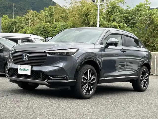 ホンダ ヴェゼル ハイブリッド e:HEV Z 長崎県 2023(令5)年 1.3万km メテオロイドグレーメタリック ワンオーナー/プッシュスタート/保証書/取扱説明書/スマートキー/渋滞追従機能付きアダプティブクルーズコントロール/Hondaコネクトディスプレイ(BT/AM/FM/フルセグ/ナビ)/USB入力端子/ETC2.0/ワイヤレス充電/バックカメラ/純正フロアマット/純正18インチアルミホイール/運転席・助手席シートヒーター/ABS/VSA(ビークルスタビリティアシスト)/LKAS(車線維持支援システム)/イモビライザーシステム/衝突軽減ブレーキ/前後ソナーセンサー/ヒルディセントコントロール/ドライブモードセレクト/パワーテールゲート/パドルシフト/オートライト/オートハイビーム