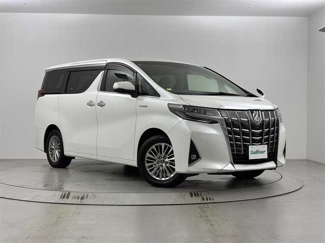トヨタ アルファードハイブリット G 埼玉県 2018(平30)年 5.1万km ホワイトパールクリスタルシャイン 純正10インチナビ　NSZN-Z66T/バックカメラ/前方ドライブレコーダー/ETC/アダプティブクルーズコントロール/車線逸脱警報/オートマチックハイビーム/クリアランスソナー/衝突軽減ブレーキ/前席シートヒーター・ベンチレーション/オットマン/ロールサンシェード/電子パーキングシステム/ブレーキホールド/フロントフォグランプ/ウィンカーミラー/電動格納ミラー/プッシュスタート/ステアリングリモコン/両側電動スライドドア/純正フロアマット/純正ドアバイザー/純正17インチアルミホイール