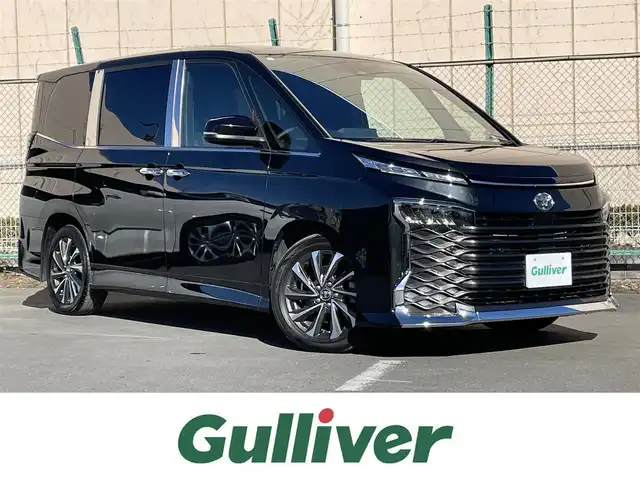 トヨタ ヴォクシー 東京都 2024(令6)年 3万km グリッターブラックガラスフレーク １０．５インチ純正ナビ　/Ｂｌｕｅｔｏｏｔｈ　/ＴＶ　/ＦＭ　/ＡＭ　/ＣＤ　/ＤＶＤ　/両側電動スライドドア　/追従型クルーズコントロールシステム　/シートヒーター　/ハーフレザーシート　/トヨタセーフティセンス/ABS/横滑り防止装置/コーナーセンサー/レーンアシスト/オートマチックハイビーム/衝突被害軽減システム