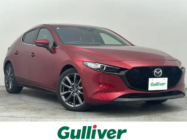 マツダ マツダ３ファストバック 15S ツーリング 道央・札幌 2020(令2)年 3.1万km ソウルレッドクリスタルM ・4WD/・純正SDナビゲーション/　CD/DVD/HDD/HDMI/フルセグ/USB/・i-ACTIVESENSE/・ビルトインETC/・社外ドライブレコーダー前後（ZRR-０１６）/・レーダークルーズコントロール/・横滑り防止装置/・前後コーナーセンサー/・オートライト/・オートマチックハイビーム/・オートブレーキホールド/・LEDヘッドライト/・MTモード付AT/・スマートキー/・プッシュスタート/・スペアキー１本/・純正フロアマット/・純正AW１８インチ/・電動格納ウィンカーミラー/・トノカバー/・取説あり
