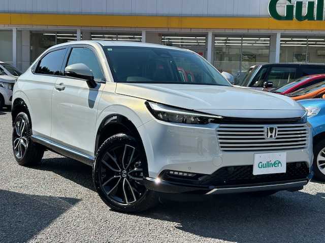 ホンダ ヴェゼル ハイブリッド e:HEV Z 神奈川県 2025(令7)年 0.1万km未満 プレミアムサンライトホワイトパール ワンオーナー/ホンダコネクトディスプレイ・ナビ・TV・USB・Bluetooth/ビルトインETC2.0/ワイヤレス充電器/革巻きハンドル/パドルシフト/ハンドルヒーター/ハーフレザーシート/前席シートヒーター/ホンダセンシング/ブラインドスポットインフォメーション/アダプティブドライビングビーム/後退出庫サポート/ハンズフリーアクセスパワーテールゲート/LEDシーケンシャルターンシグナルランプ/18インチアルミホイール/R席用USBポート×2/トノカバー/ISOFIX対応/純正フロアマット/新車時保証書/取扱説明書/スマートキー×2