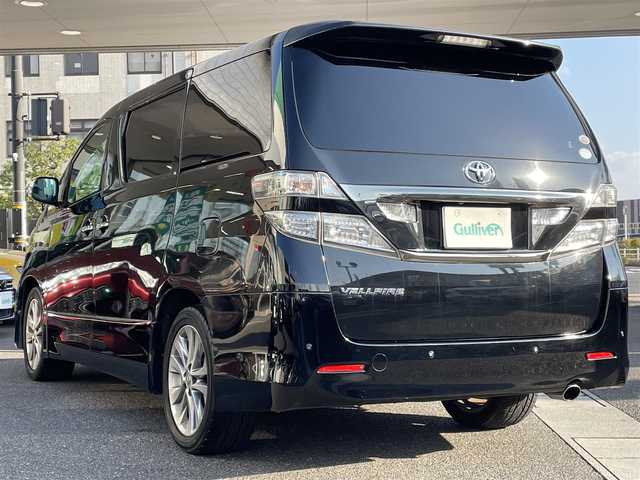 トヨタ ヴェルファイア 2．4Z プラチナセレⅡ ゴールド 岡山県 2011(平23)年 10.8万km ブラック 登録時走行距離107601km/フリップダウン後席モニター/社外SDナビ/(AM/FM/DISC/TV/BT)/クルーズコントロール/両側パワースライドドア/電動リアゲート/ビルトインETC/バックカメラ/ウォークスルー/MTモード付AT/プッシュスタート/スマートキー/スペアキー/純正１８インチアルミホイール/キセノンヘッドライト