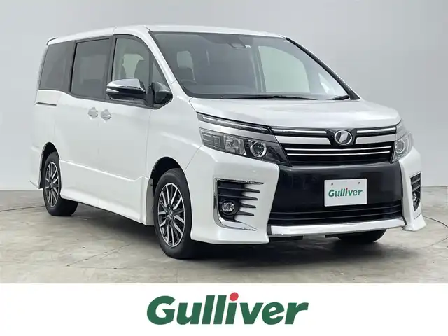 トヨタ ヴォクシー ZS 煌Ⅱ 千葉県 2016(平28)年 8.8万km ホワイトパールクリスタルシャイン 禁煙車/Toyota Safety Sense C/・プリクラッシュブレーキ/・レーンキーピングアシスト/・ハイビームアシスト/・横滑り防止装置 /・衝突安全ボディ/両側パワースライドドア/社外8インチナビ/CD/DVD/Bluetooth/フルセグ/バックカメラ/LEDオートライト/純正16インチアルミホイール/純正フロアマット/オートエアコン/アイドリングストップ/プッシュスタート/スマートキー