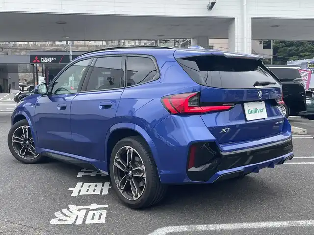 ＢＭＷ ＢＭＷ Ｘ１ 長崎県 2023(令5)年 1.3万km 青 ワンオーナー/車体色ポルティマオブルー(C31)/BMW　iDrive(BT/AM/FM/Spotify/AppleCarPlay/AndroidAuto/NAVI)/ルームミラー内蔵ETC/D+N席パワーシート/D+N席シートヒーター/エアシート/ヘッドアップディスプレイ/革巻きステアリング/ステアリングヒーター/ステアリングスイッチ/追従有りクルーズコントロール/ターボチャージャー搭載車/Assisted Drive Mode/ABS/ダイナミックスタビリティコントロール/アダプティブヘッドライト/レーンチェンジアシスト/アラームシステム/オートライトコントロール/ハイビームアシスト/ヒルディセントコントロール/アダプティブブレーキアシスタント/強化走行ダイナミクス/パークアシスト/制限速度アシスト/スペアキー(スマートキー1本)/カードキー/純正フロアマット/純正19インチアルミホイール/車両/ETC取扱説明書/保証書