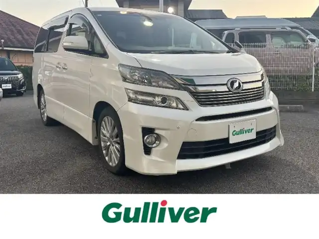 トヨタ ヴェルファイア 2．4Z Gエディション 愛知県 2013(平25)年 12.2万km ホワイトパールクリスタルシャイン ワンオーナー/4WD/両側パワースライドドア/純正フリップダウンモニター/純正HDDナビ(ワンセグ/BT/BD/DVD/CD/USB/ラジオ）/バックカメラ/ETC/クルーズコントロール/ABS/横滑り防止装置/盗難防止装置/オートライト/前後コーナーセンサー/シートポジションメモリー/レザーシート/パワーシート/シートヒーター/チップアップシート/オットマン/純正フロアマット/純正アルミホイール/パワーステアリング/パワーウィンドウ/ドアバイザー/フォグランプ/スマートキー/スペアキー/保証書/取扱説明書