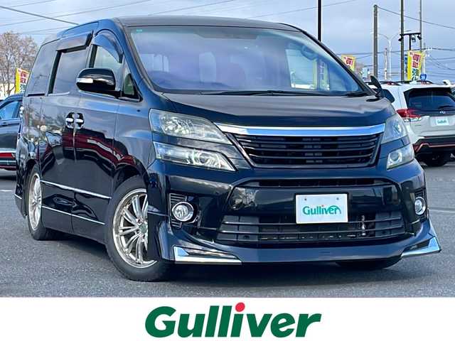 トヨタ ヴェルファイア 2．4Z Gエディション 道央・札幌 2012(平24)年 8.4万km ブラック ４WD/純正ディーラーOPナビ/CD/DVD/BT/フルセグ/純正フリップダウンモニター/横滑り防止装置/クルーズコントロール/クリアランスソナー/パーキングアシスト/センターデフロック/バックカメラ/ビルトインETC/ドライブレコーダー/ECOMODE/nanoe/両側パワースライドドア/パワーバックドア/前席/２列目パワーシート/D席メモリーシート/N席/２列目オットマン/革巻きウッドコンビステアリング/ステアリングリモコン/MTモード付AT/プッシュスタート/スマートキー/HIDヘッドライト/オートライト/フォグランプ/電動格納ミラー/ウィンカーミラー/純正フロアマット/ドアバイザー/スペアキー/社外エンジンスターター