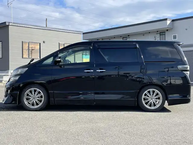 トヨタ ヴェルファイア 2．4Z Gエディション 道央・札幌 2012(平24)年 8.4万km ブラック ４WD/純正ディーラーOPナビ/CD/DVD/BT/フルセグ/純正フリップダウンモニター/横滑り防止装置/クルーズコントロール/クリアランスソナー/パーキングアシスト/センターデフロック/バックカメラ/ビルトインETC/ドライブレコーダー/ECOMODE/nanoe/両側パワースライドドア/パワーバックドア/前席/２列目パワーシート/D席メモリーシート/N席/２列目オットマン/革巻きウッドコンビステアリング/ステアリングリモコン/MTモード付AT/プッシュスタート/スマートキー/HIDヘッドライト/オートライト/フォグランプ/電動格納ミラー/ウィンカーミラー/純正フロアマット/ドアバイザー/スペアキー/社外エンジンスターター