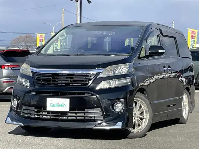 トヨタ ヴェルファイア 2．4Z Gエディション 道央・札幌 2012(平24)年 8.4万km ブラック ４WD/純正ディーラーOPナビ/CD/DVD/BT/フルセグ/純正フリップダウンモニター/横滑り防止装置/クルーズコントロール/クリアランスソナー/パーキングアシスト/センターデフロック/バックカメラ/ビルトインETC/ドライブレコーダー/ECOMODE/nanoe/両側パワースライドドア/パワーバックドア/前席/２列目パワーシート/D席メモリーシート/N席/２列目オットマン/革巻きウッドコンビステアリング/ステアリングリモコン/MTモード付AT/プッシュスタート/スマートキー/HIDヘッドライト/オートライト/フォグランプ/電動格納ミラー/ウィンカーミラー/純正フロアマット/ドアバイザー/スペアキー/社外エンジンスターター