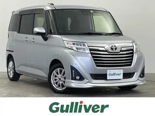 トヨタ ルーミー カスタムG－T 千葉県 2020(令2)年 3.3万km ブライトシルバーM スマートアシスト3/・衝突回避支援ブレーキ機能/・衝突警報機能/・車線逸脱警報機能/・誤発進抑制制御機能/・先行者発進お知らせ機能/・オートハイビーム/・コーナーセンサー/純正9インチメモリーナビ/・フルセグTV/・Bluetooth/・CD/DVD再生/・バックカメラ/両側パワースライドドア/スマートキー/LEDヘッドライト/前後コーナーセンサー/ビルトインETC/フロントスポイラー/社外AW+スタッドレスT