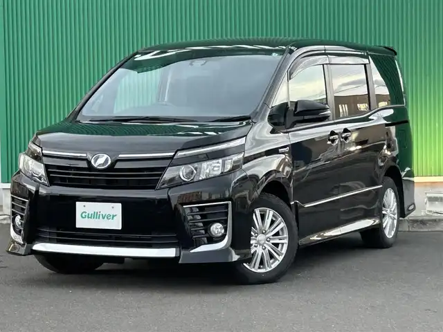 トヨタ ヴォクシー ハイブリッド ZS 宮城県 2016(平28)年 11.2万km ブラック 純正SDナビ　/(NSZT -W66T/フルセグTV)/フリップダウンモニター/(ALPINE10インチ)/バックカメラ/両側パワースライドドア/セーフティセンスC/・プリクラッシュセーフティシステム/・レーンディパーチャーアラート/・オートマチックハイビーム/LEDヘッドライト/スマートキー/ETC/純正アルミ16インチ(サマータイヤ)積み込み/取扱説明書/スペアキー