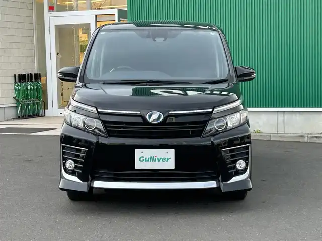 トヨタ ヴォクシー ハイブリッド ZS 宮城県 2016(平28)年 11.2万km ブラック 純正SDナビ　/(NSZT -W66T/フルセグTV)/フリップダウンモニター/(ALPINE10インチ)/バックカメラ/両側パワースライドドア/セーフティセンスC/・プリクラッシュセーフティシステム/・レーンディパーチャーアラート/・オートマチックハイビーム/LEDヘッドライト/スマートキー/ETC/純正アルミ16インチ(サマータイヤ)積み込み/取扱説明書/スペアキー