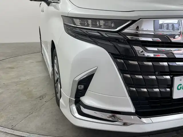 トヨタ アルファード Z 群馬県 2023(令5)年 1.9万km プラチナホワイトパールマイカ ・純正１４インチディスプレイオーディオ＜フルセグTV＞/・バック/サイドカメラ/・両側パワースライドドア/・前後ドライブレコーダー/・シートヒーター /・エアシート/・オットマン/・レーンアシスト /・横滑り防止装置/・盗難防止装置/・ABS/・オートライト/・オートマチックハイビーム/・純正フロアマット/・モデリスタエアロ/マフラー/・LEDヘッドライト/・純正１８インチアルミホイール