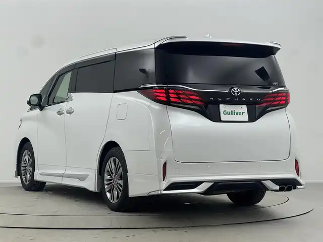 トヨタ アルファード Z 熊本県 2023(令5)年 1.9万km プラチナホワイトパールマイカ ・純正１４インチディスプレイオーディオ＜フルセグTV＞/・バック/サイドカメラ/・両側パワースライドドア/・前後ドライブレコーダー/・シートヒーター /・エアシート/・オットマン/・レーンアシスト /・横滑り防止装置/・盗難防止装置/・ABS/・オートライト/・オートマチックハイビーム/・純正フロアマット/・モデリスタエアロ/マフラー/・LEDヘッドライト/・純正１８インチアルミホイール