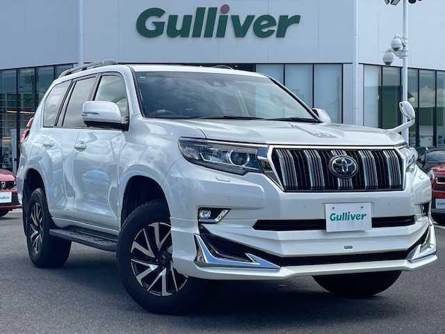 トヨタ ランドクルーザー プラド TX 長崎県 2018(平30)年 7.4万km ホワイトパールクリスタルシャイン 純正メモリーナビ/CD/DVD/BT/フルセグTV/バックカメラ/ウッドコンビハンドル（OP）/モデリスタフロントエアロ/トヨタセーフティセンス/レーダークルーズコントロール/レーンキープアシスト/ステアリングスイッチ/LEDヘッドライト/オートマチックハイビーム/ルーフレール/ドライブレコーダー/社外17インチAW/ビルトインETC