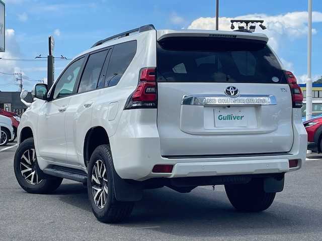 トヨタ ランドクルーザー プラド TX 長崎県 2018(平30)年 7.4万km ホワイトパールクリスタルシャイン 純正メモリーナビ/CD/DVD/BT/フルセグTV/バックカメラ/ウッドコンビハンドル（OP）/モデリスタフロントエアロ/トヨタセーフティセンス/レーダークルーズコントロール/レーンキープアシスト/ステアリングスイッチ/LEDヘッドライト/オートマチックハイビーム/ルーフレール/ドライブレコーダー/社外17インチAW/ビルトインETC