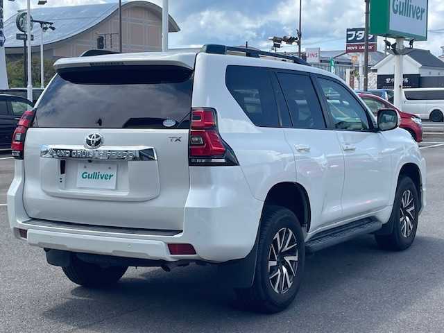トヨタ ランドクルーザー プラド TX 長崎県 2018(平30)年 7.4万km ホワイトパールクリスタルシャイン 純正メモリーナビ/CD/DVD/BT/フルセグTV/バックカメラ/ウッドコンビハンドル（OP）/モデリスタフロントエアロ/トヨタセーフティセンス/レーダークルーズコントロール/レーンキープアシスト/ステアリングスイッチ/LEDヘッドライト/オートマチックハイビーム/ルーフレール/ドライブレコーダー/社外17インチAW/ビルトインETC